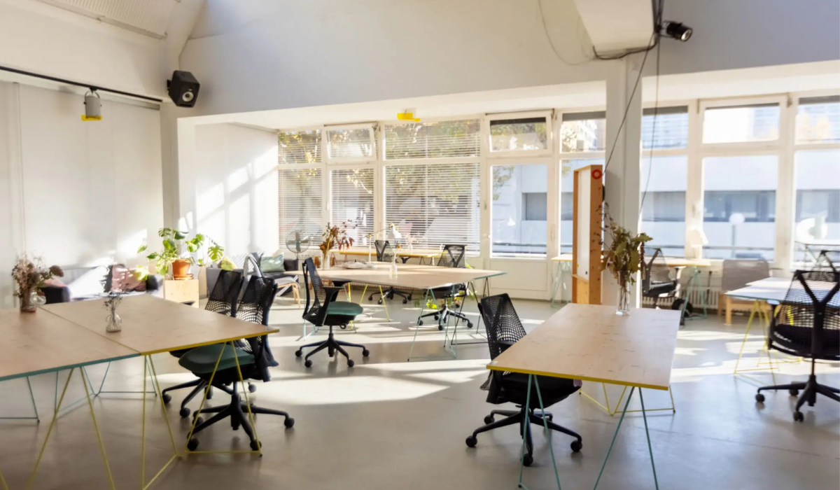 Bright and airy modern coworking space with desks and chairs.