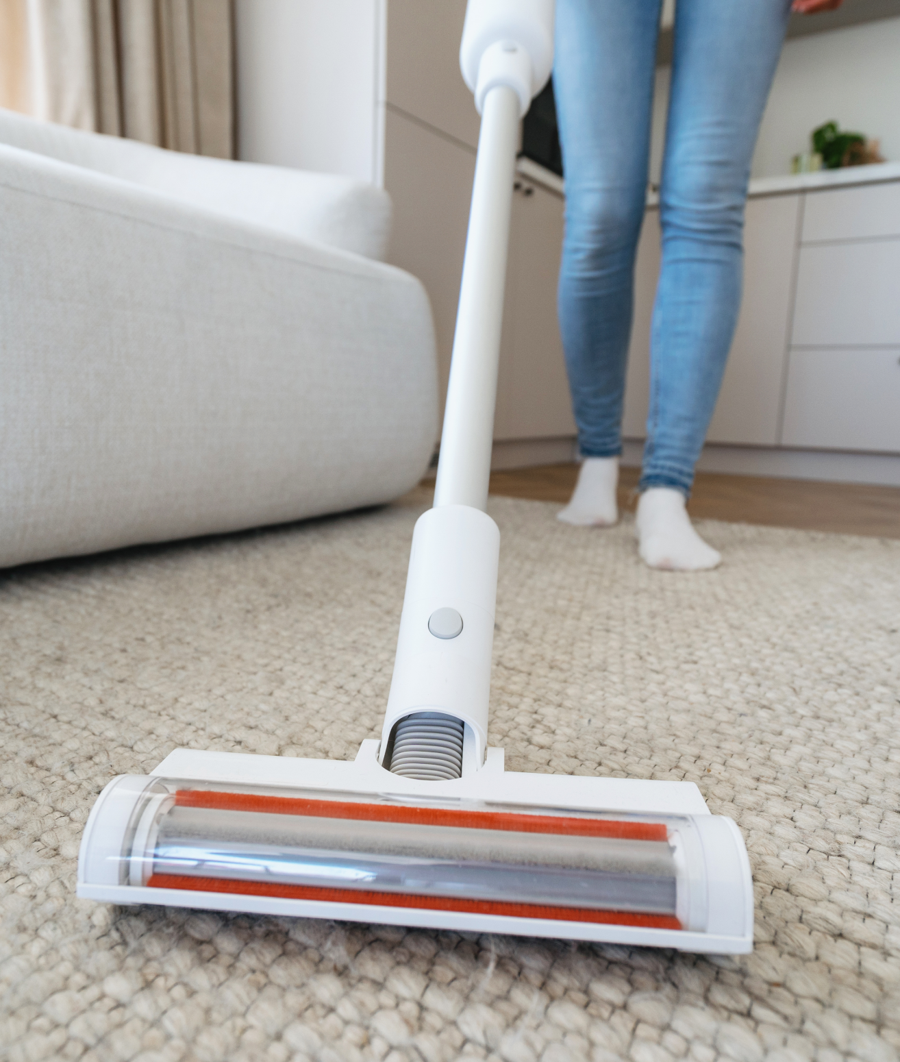 Vacuuming carpet in modern living room