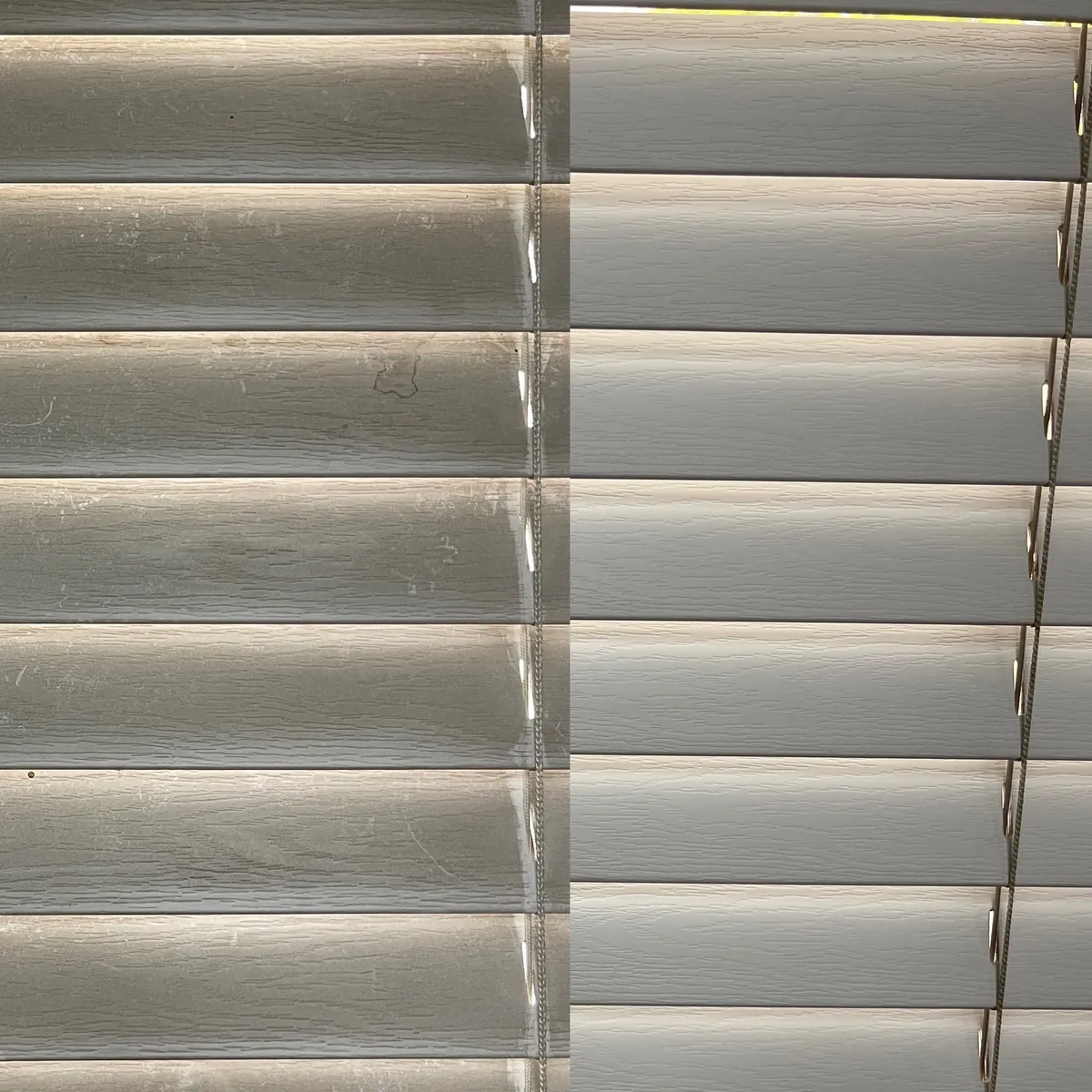 Close-up of two window blinds with different shades of white and beige.